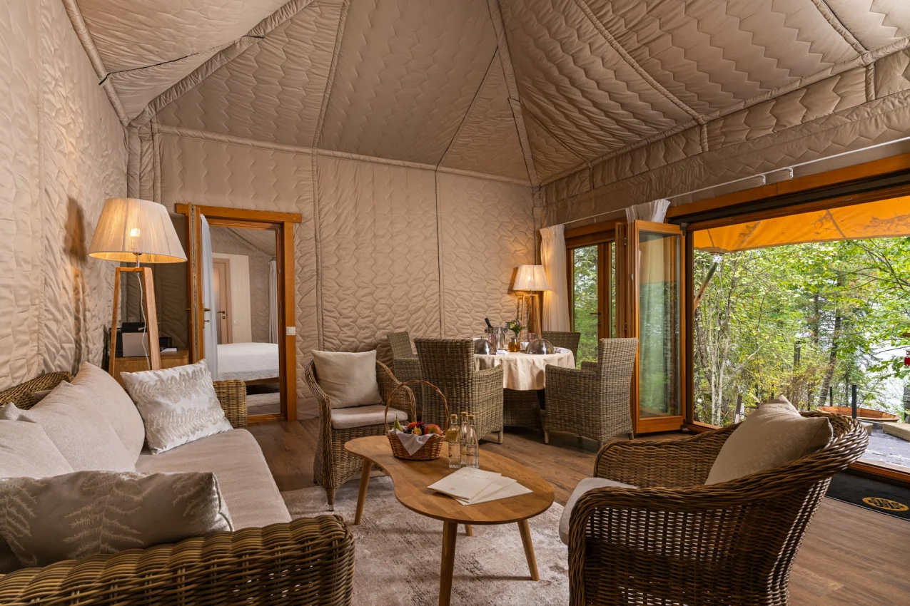 Custom glamping tent living area with spacious lounge and panoramic windows