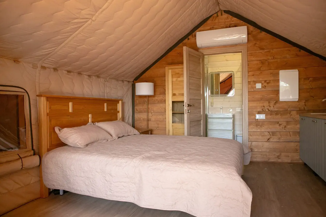 Bedroom inside a safari glamping tent